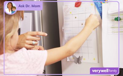 Image of a toddler and a parent putting stickers on a reward chart