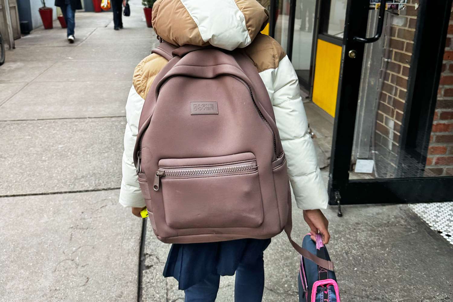 A child wearing the Dagne Dakota Backpack