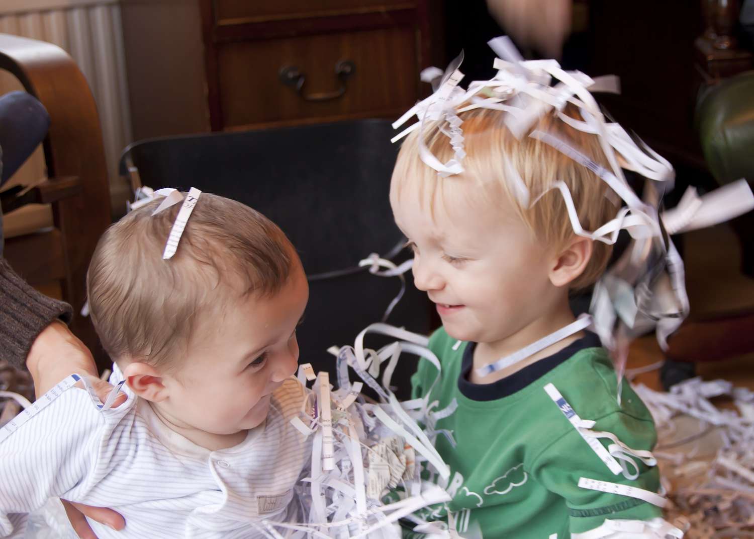 Boys playing with shredded paper