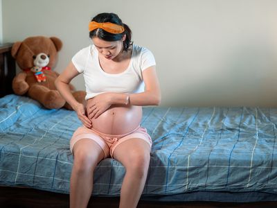 Pregnant woman putting Bio-Oil on belly