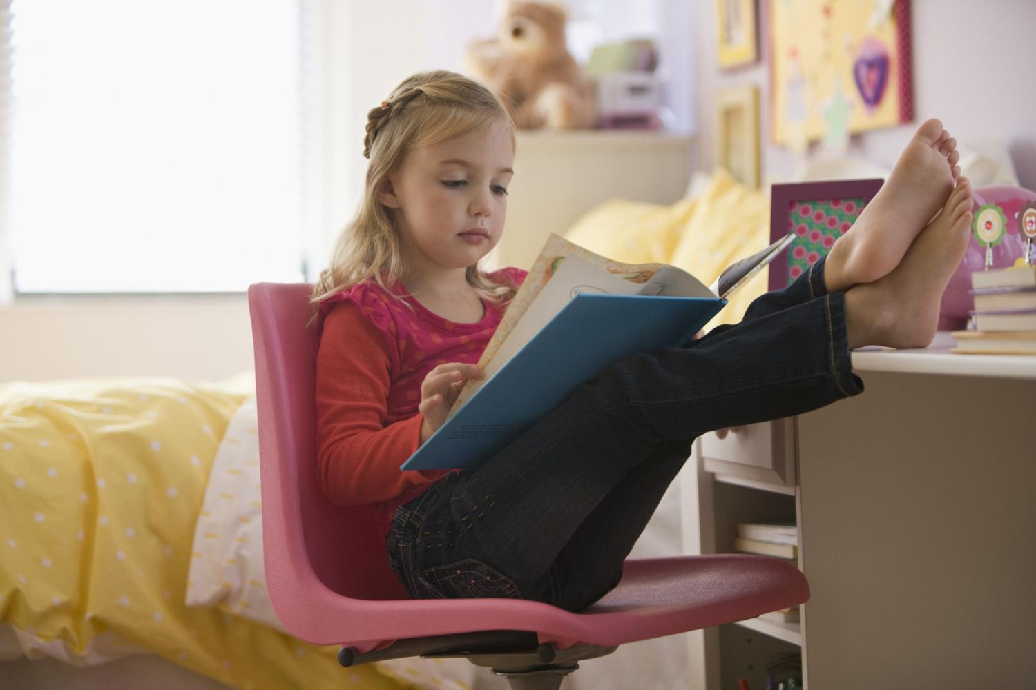 girl reading book with feet up