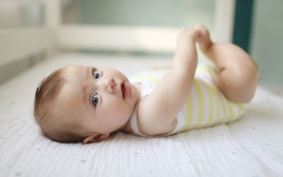 baby in yellow and white stripes