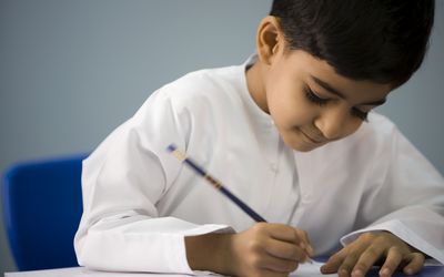 一个小男孩在教室里做作业。