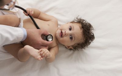 baby being examined by a pediatrician