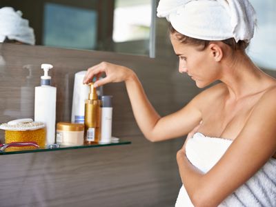 Woman picking lotion after shower