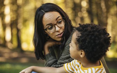 Mother talking to son outdoors