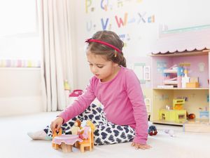 A girl playing dolls