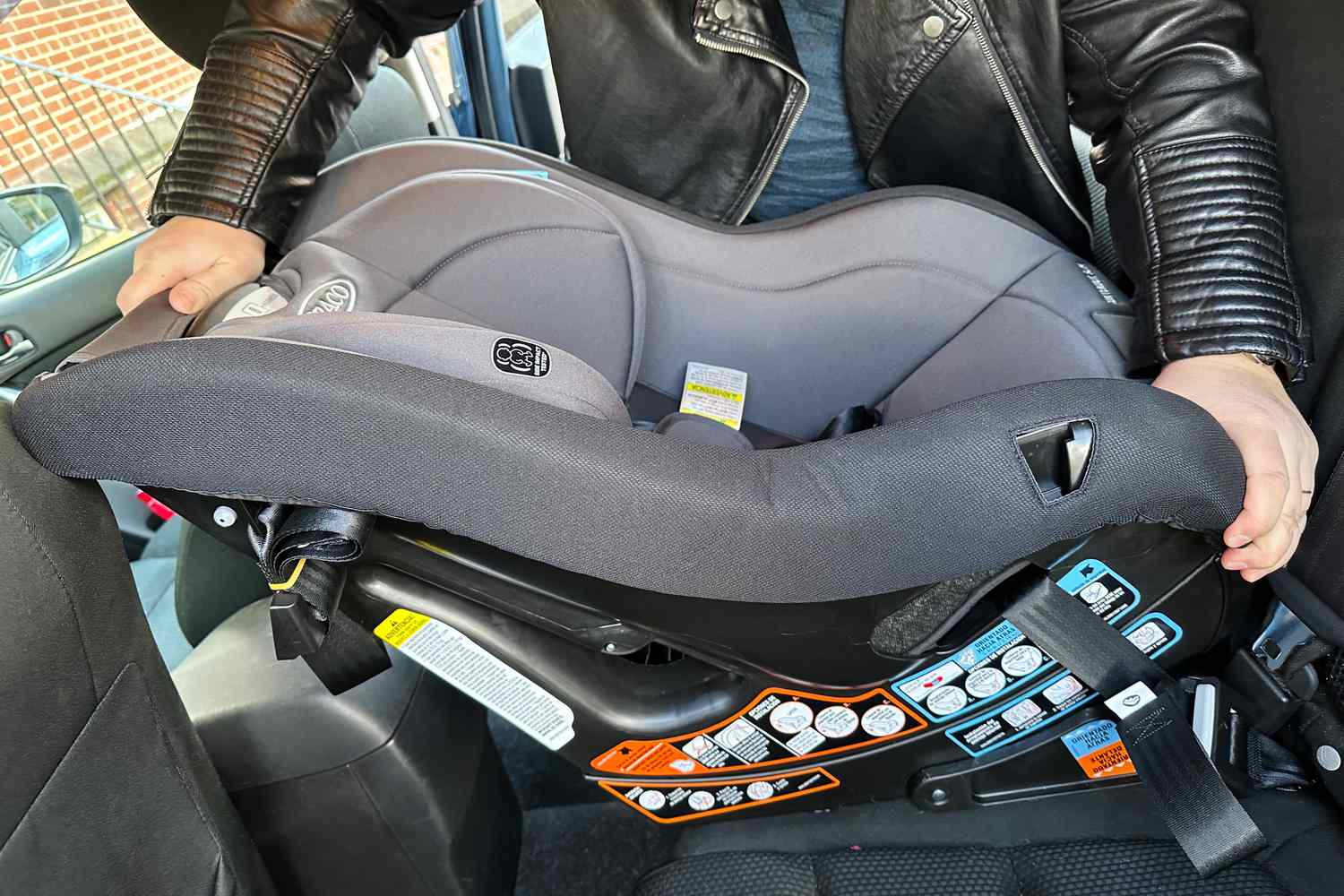 Person installing the Graco Contender Slim Convertible Car Seat