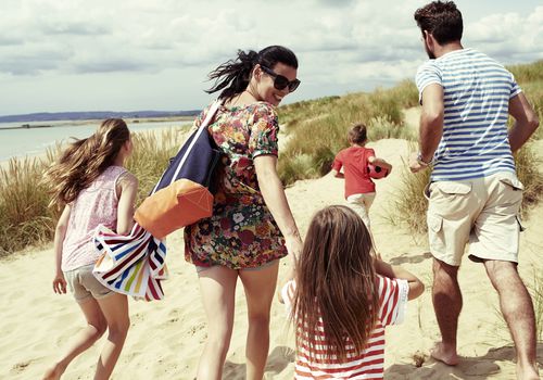 family heading to the beach