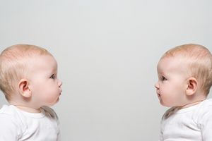 Identical twins facing each other