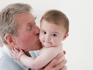 Grandfather kissing grandson