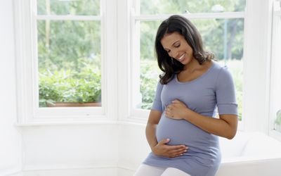 Pregnant woman holding her belly