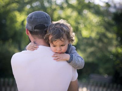 dad holding sad son