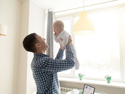 Dad holding a baby up