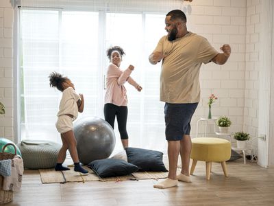 Father and his two daughters exercising at home