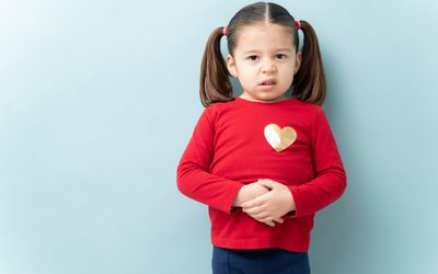 Young girl holding stomach