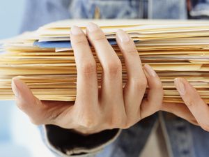 Woman holding folders, close-up