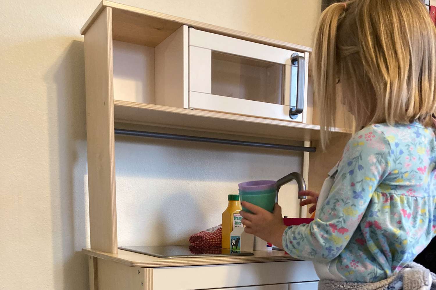 Toddler girl playing withIKEA Duktig Play Kitchen