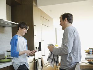 Father and son talking in kitchen