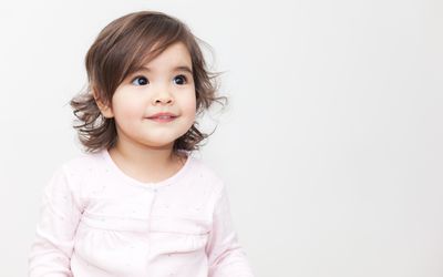 Girl smiling in long sleeve pink shirt