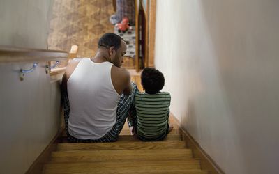 Father sitting with son on the stairs