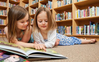 Girls reading in a school library.