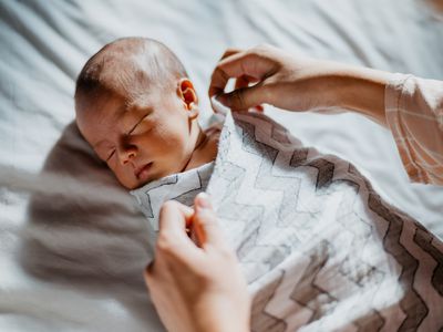 Baby being swaddled