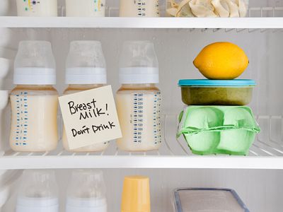 Bottles of breast milk in the refrigerator with sign that says don't drink