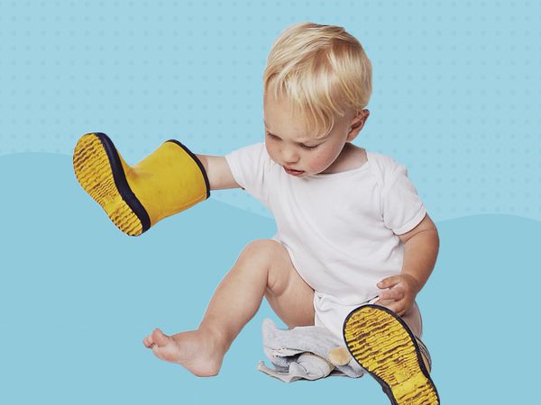 baby with yellow rain boots collaged against a blue background