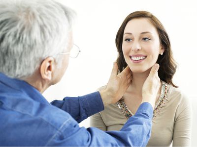 Doctor checking a patient's glands