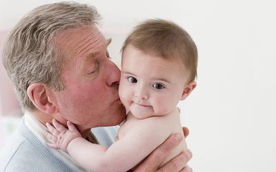 Grandfather kissing grandson