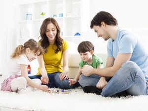 Family Playing Board Game at home