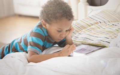 Young boy looking at digital tablet