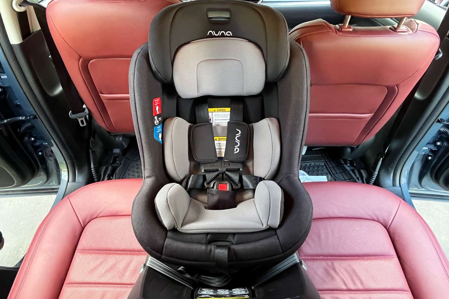 The Nuna REVV Rotating Convertible Car Seat strapped into a car