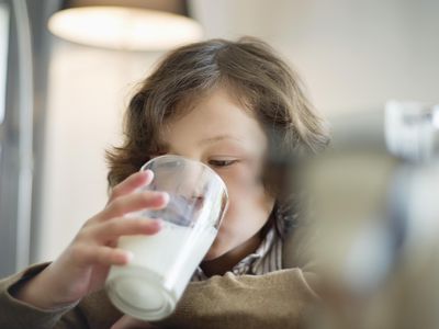 Close-up of a boy drinking a glass of milk