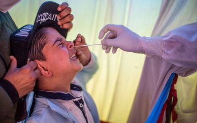 Kid gets nasal swab COVID test