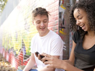 Two teens looking at a cellphone