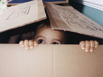 Baby hiding in a cardboard box