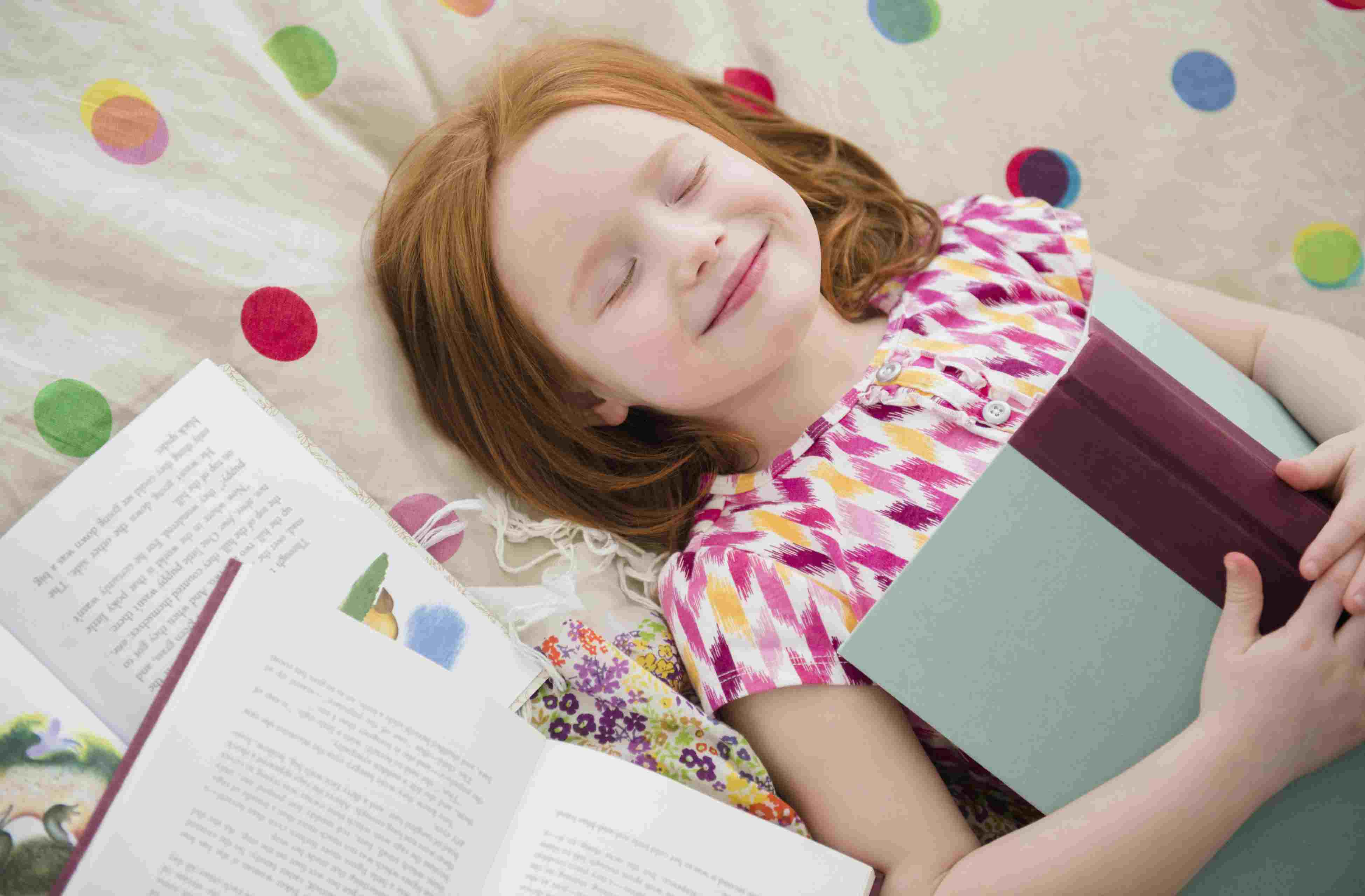 girl smiling with books, loves reading