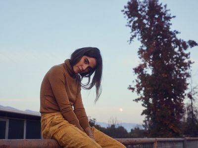 Nikki Reed in a turtleneck and jeans at dusk