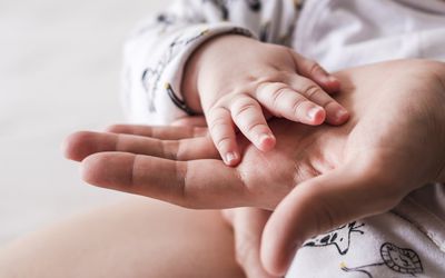 Baby hand in parent's hand