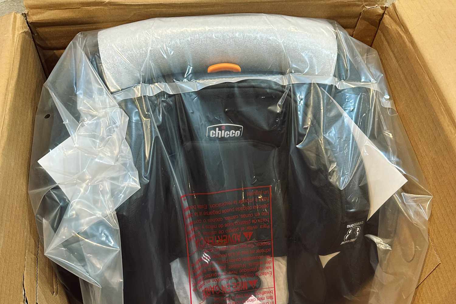The Chicco OneFit ClearTex All-in-One Car Seat in its packaging