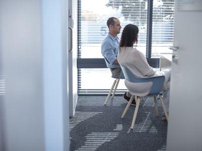 Couple sitting in consulting room at the doctor