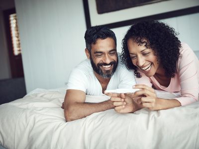 A smiling couple looking at a pregnancy test