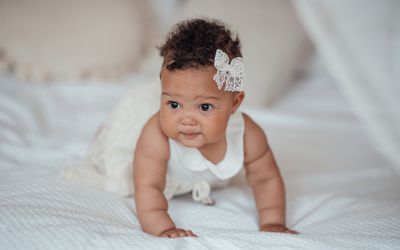 Portrait Of Cute Baby On Bed