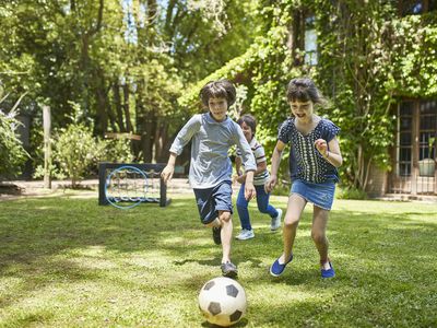 Group of 7 Year Old Footballers Playing in Family Backyard