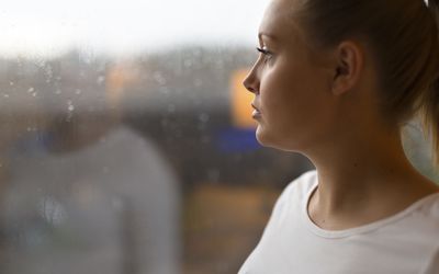 Thoughtful woman looking out the window