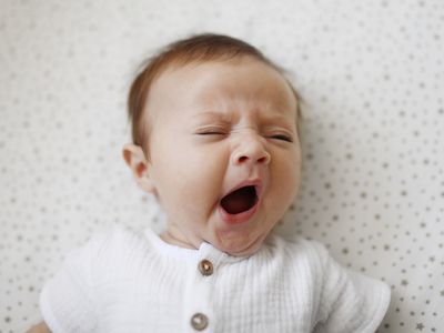 A 4 month old baby girl yawning - stock photo