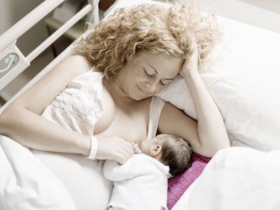 Mother breastfeeding newborn in the hospital