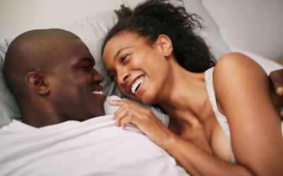 Couple laughing on bed